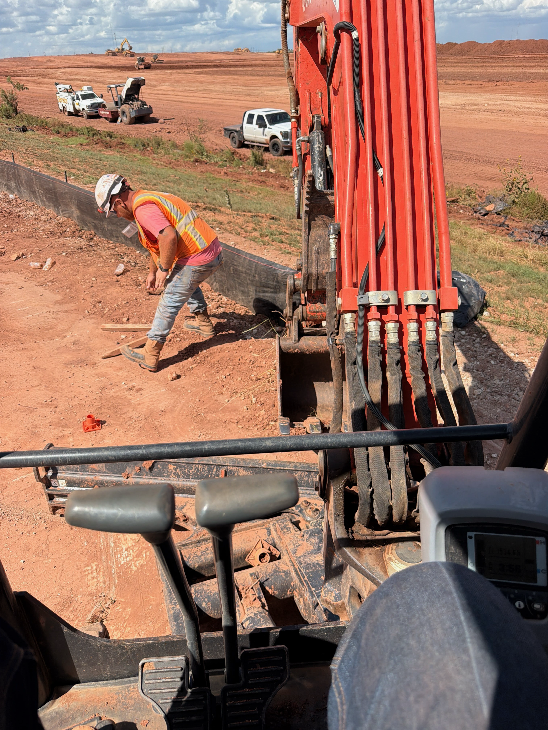 Trinity Environmental field crew working beside heavy equipment on an active construction site