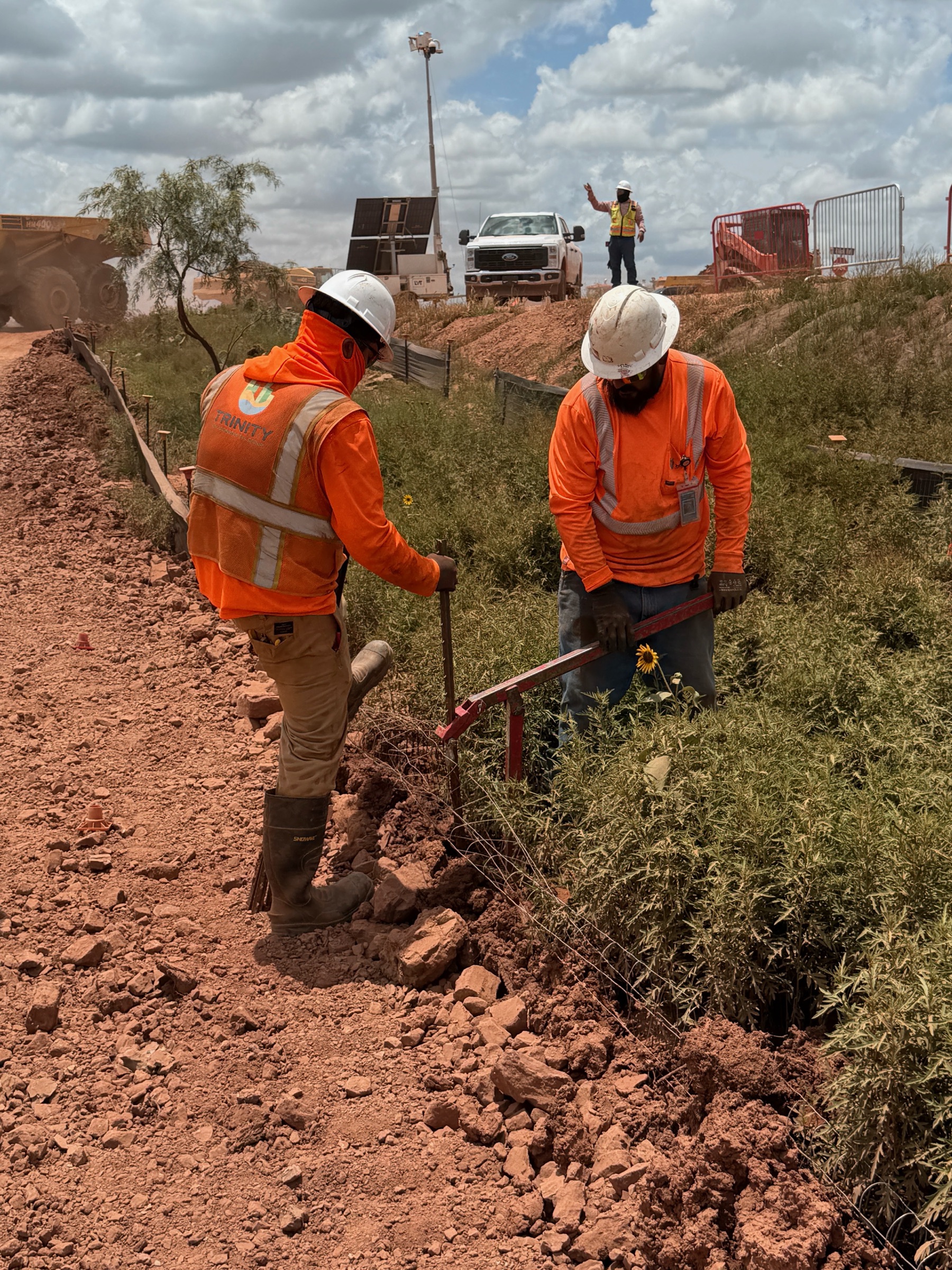 Trinity Environmental crew members installing erosion and sediment controls on a construction site