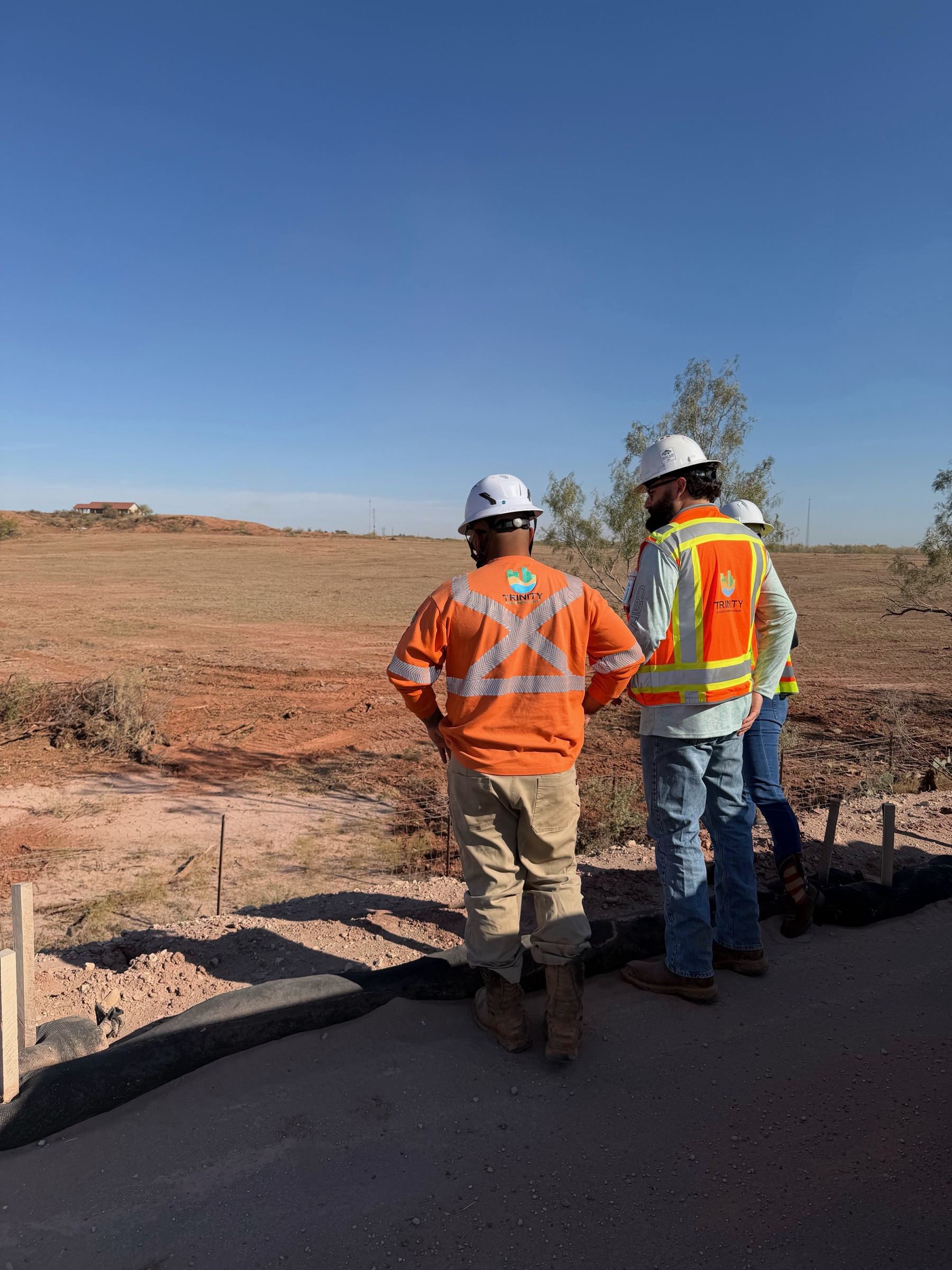 Trinity Environmental team members reviewing conditions on an active construction site